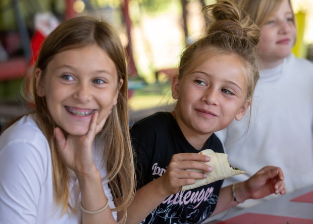 El Granada Elementary School third graders taste the veggie tacos they made after harvesting produce during a field trip with the Heal Project, Wednesday, Oct. 23, 2024, Half Moon Bay, Calif. (Karl Mondon/Bay Area News Group)