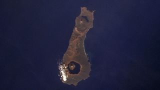 Aerial photo of Onekotan Island showing Krenitsyna Volcano and Nemo Volcano at either end of the island.