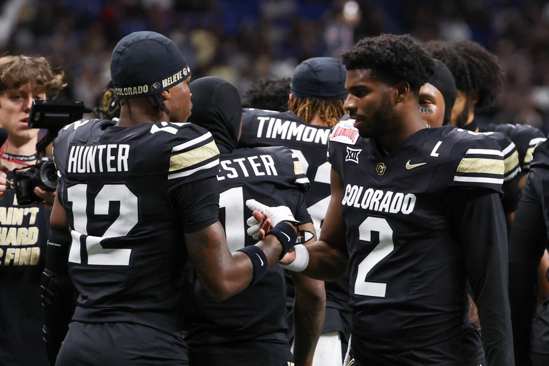 SAN ANTONIO, TX - DECEMBER 28: Colorado Buffaloes quarterback Shedeur Sanders (2) and Colorado Buffaloes wide receiver Travis Hunter (12) high five before the football game between the BYU Cougars and Colorado Buffalos on December 28, 2024 , the Alamodome at. San Antonio, Texas. (Photo by David Buono/Icon Sportswire via Getty Images)